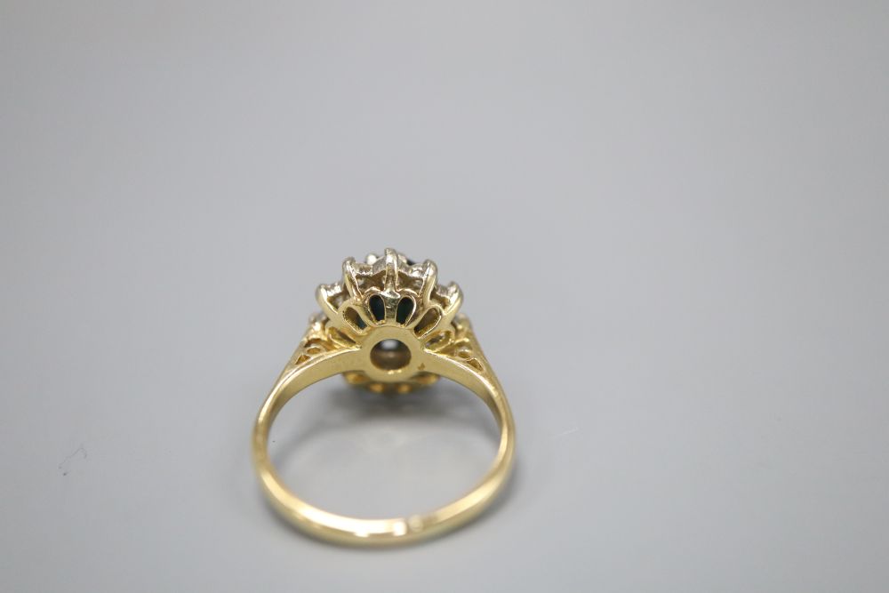 An 18ct gold sapphire and diamond oval cluster ring, size J